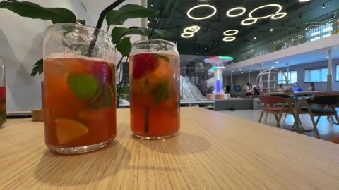 Two refreshing fruit cocktails with lime, mint, and strawberries Stock Footage 317672308