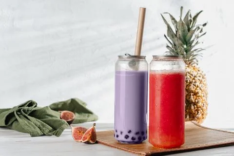 Two Refreshing Iced To-Go Bubble Tea With Straws And Fresh Fruits Stock Photos