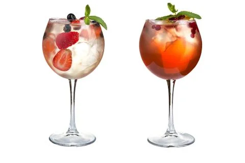 Two refreshing light cocktails with mint, fruits and berries on a white backg Stock Photos