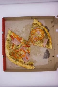 Two Remaining Slices of Pizza with Ham in Box Stock Photos