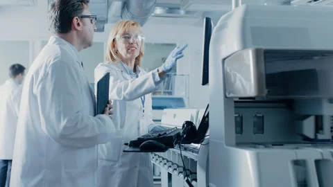 Two Research Scientists Programm Medical Equipment with Computer Keyboard. Vidéo 96745451