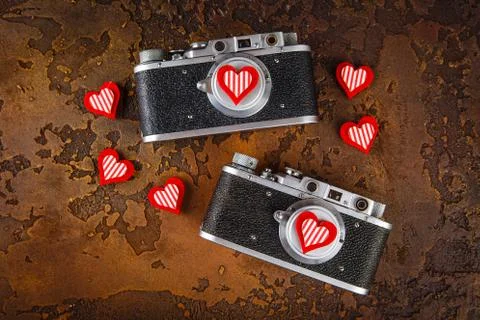 Two retro camera and hearts Stock Photos