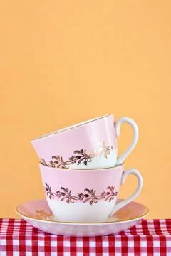 Two retro style teacups on gingham cloth Stock Photos