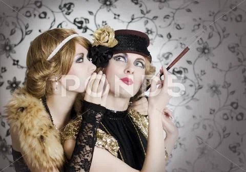Two retro styled women sharing secrets Stock Photos