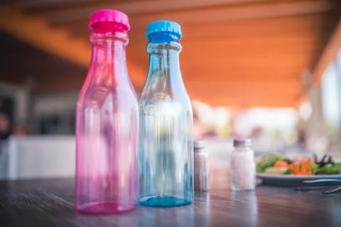 Two Reusable Plastic Drink Bottles on a table. Concept of recycling. Enviroment Stock Photos
