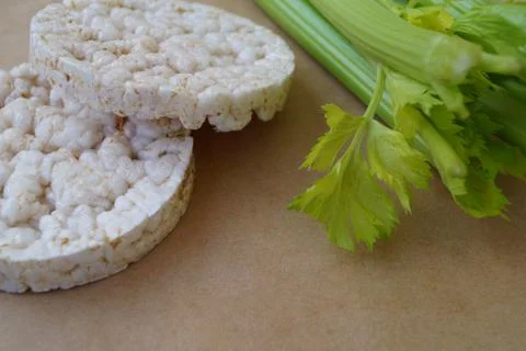 Two rice white round bread with fresh green stem celery healthy food organic pro Stock Photos