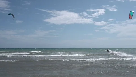 Two riders starting to ride waves during a windy day Stock Footage 121041964