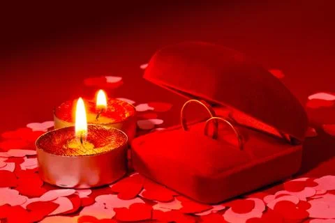 Two rings in a box and two candles Stock Photos