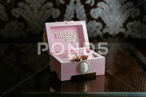Two Rings In A Box With Wedding Day Inscription On Dark Table. Concept Of