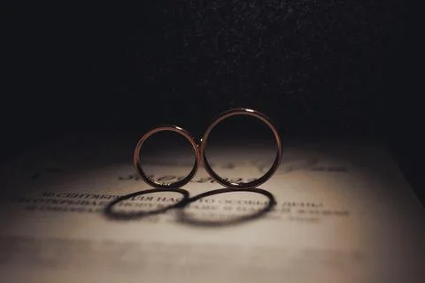 Two rings rest gently on a document Fotos Stock