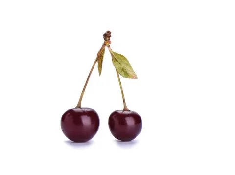 Two ripe cherries with cherry leaf isolated on a white backgroun Stock-Fotos