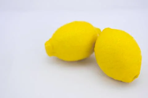 Two ripe lemons on white background Stock Photos