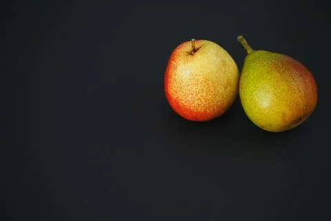 Two ripe pears on a black background. Stock-Fotos
