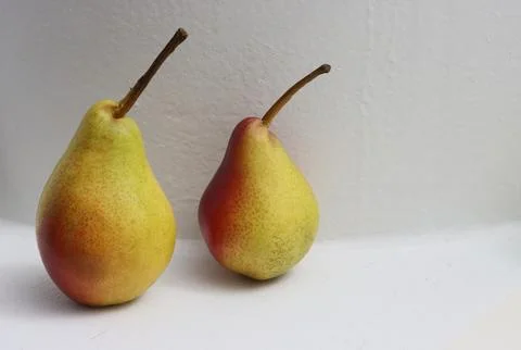 Two ripe pears on a white background. Stock Photos