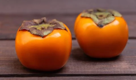 Two ripe persimmons Stock Photos
