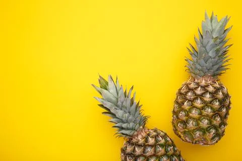 Two ripe pineapples on a yellow background Stock Photos