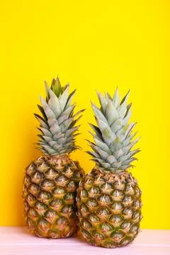 Two ripe pineapples on a yellow background Stock Photos