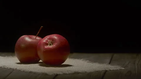 Two ripe red apples resting on an empty table. Stock Footage 324745774