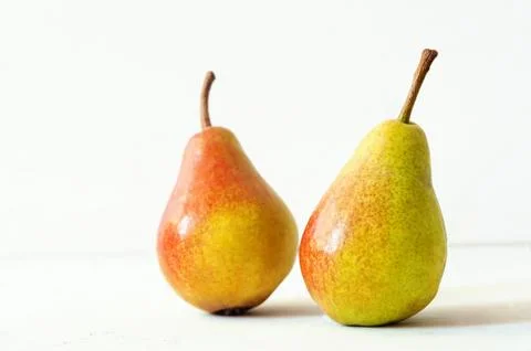 Two ripe red yellow pear fruits on white background Stock Photos