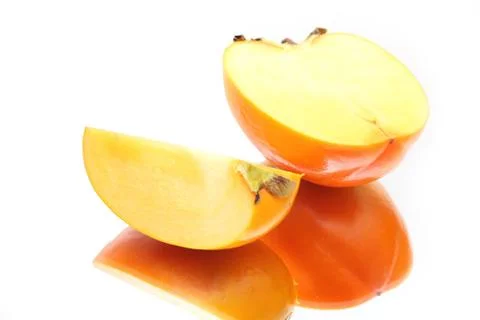 Two ripe slices of a persimmon Stock Photos