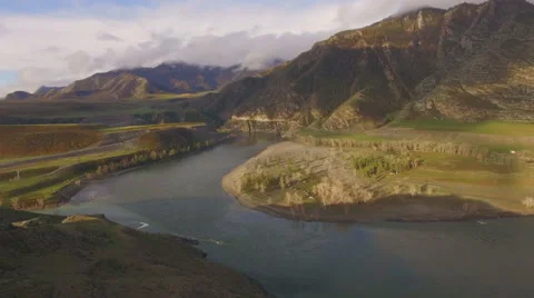 Two rivers merge into the beautiful mountain landscape, aerial view Stock Footage 67564071