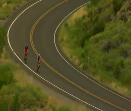 Two Road Bikes ride through Capitol Reef... | Stock Video | Pond5