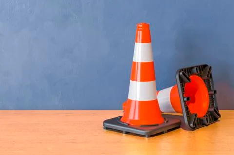 Two Road Cones on the wooden table. 3D rendering Stock Illustration