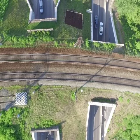 Two road tunnel which takes traffic from above railway tracks Stock Footage 69574517
