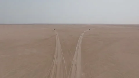 Two off-road vehicles part ways on vast desert road to Bar Al Hikman, Oman Stock Footage 305247407