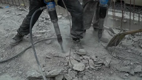 Two road workers loosens old asphalt with a pneumatic jackhammer. renovating Video stock 212444794