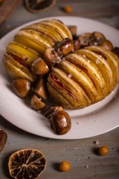 Two roasted filled potatoes with fried mushrooms on white plate Stock Photos