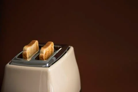 Two roasted pieces of bread on toaster Stock Photos