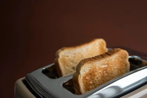 Two roasted pieces of bread on toaster Stock Photos