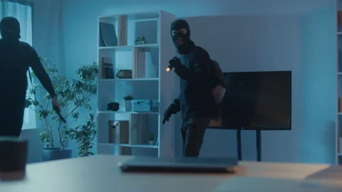 Two Robbers in Black Clothes and a Mask Broke Into an Apartment or House. Video stock 239884344