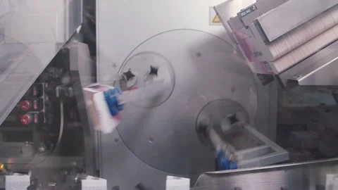 Two robotic devices taking the drug packs with russian title means amlodipine Stock Footage 200856870