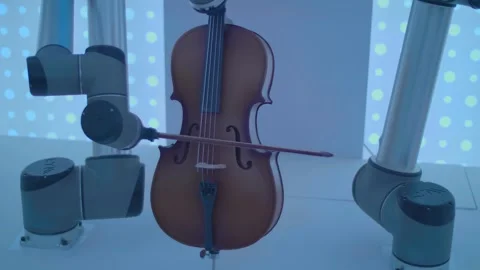 Two robotic hands skillfully play a melody on the cello Stock Footage 324016395