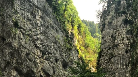 Two rocks forming a gorge in a mountainous wooded area Stock Footage 128142533