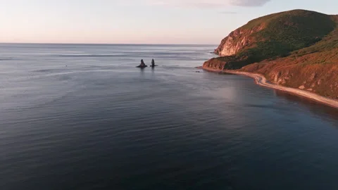 Two rocks in the ocean at dawn Video stock 266939699