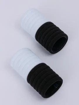 Two rolled black and white terry hair ties Stock Photos