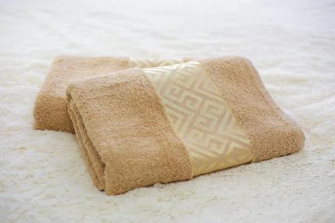Two rolled towels on the bed Stock Photos
