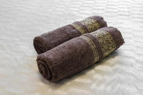 Two rolled towels close-up on the bed Photos