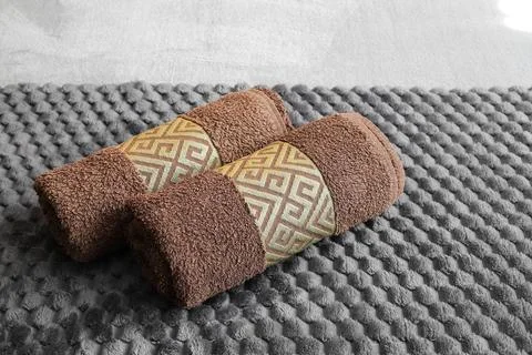 Two rolled towels close-up on the bed Stock Photos