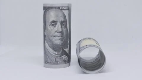 Two rolled-up US one hundred dollar bills placed on a white background. Stock Photos