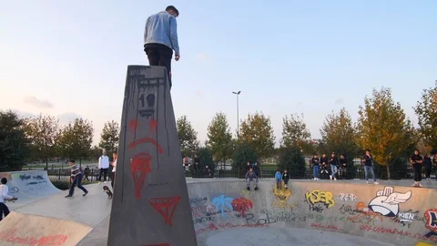 Two Roller Skaters Doing a Flip Trick in Skate Park Slow Motion Stock Footage 121007644