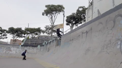 Two rollerbladers jump at skatepark, one of them falls Stock Footage 171491906