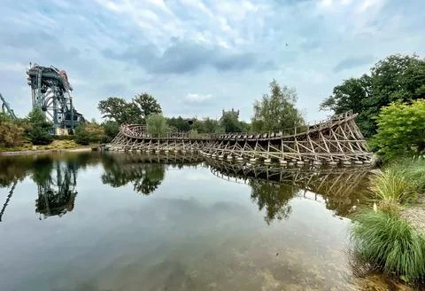 Two rollercoasters next to a lake in a themepark Stock Photos