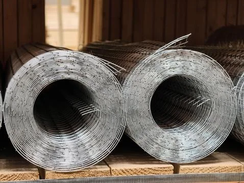 Two rolls of galvanized welded metal mesh displayed on a shelf in a modern .. Stock Photos