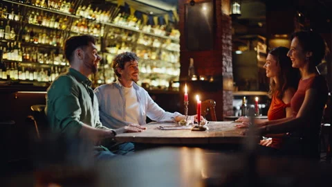 Two romantic couples dating in modern restaurant. Pair beautiful women came Vídeo Stock 334033162