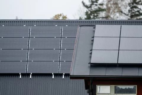 Two roofs with solar panels Stock Photos