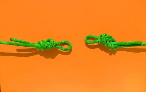 Two ropes with secure knots. climbing rope with a knot lies on a colored back Stock Photos